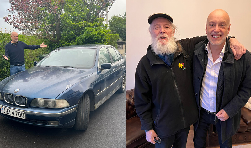 Andrew Scott stands beside his old BMW and shares a heartfelt moment with a companion, symbolising his journey from hardship to building a multi-million-pound business. The image connects his past struggles with his inspiring success story.