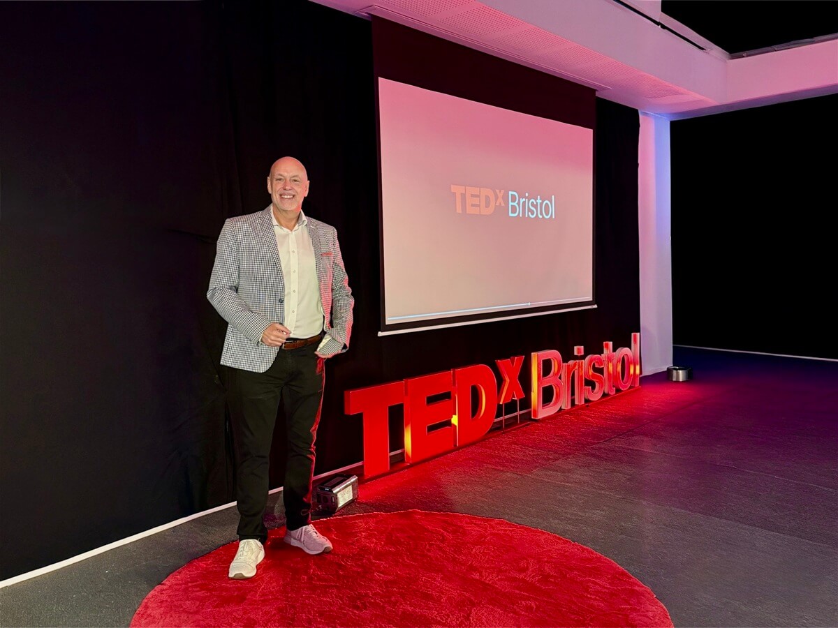 Andrew Scott standing on the red circle at TEDxBristol before delivering his TEDx Talk