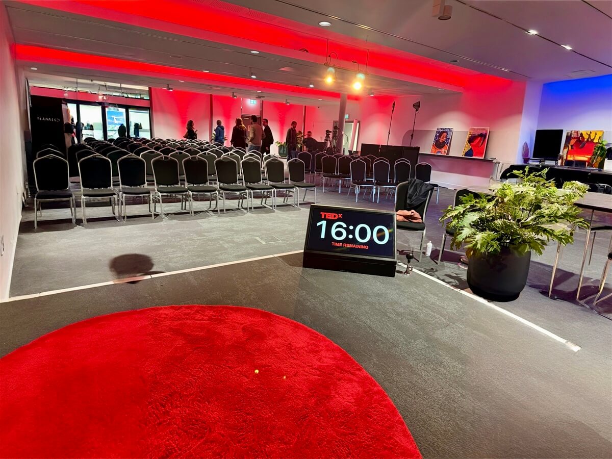 View from the stage during Andrew Scott’s TEDx Talk at TEDxBristol showing the red circle and audience setup